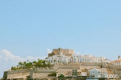 An illustrative photo of city buildings under blue sky.