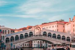 An illustrative image of a boat near the Rialto bridge in Venice