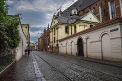 An illustrative photo of a cobblestone street lined with old buildings