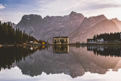 An illustrative photo of a building on a lake.