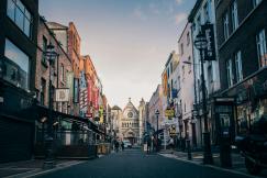 An illustrative photo of people walking on a street towards a church
