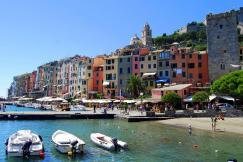 An illustrative photo of multicolored buildings near body of water