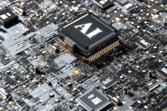 An illustrative photo of a computer chip with the letters “AI” on it
