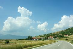 An illustrative photo of a green grass field under blue sky.