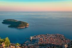 An illustrative photo of an aerial view of a historic coastal town near the calm sea