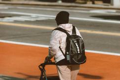 An illustrative photo of an individual using a four-wheeled walker