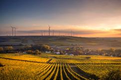 An illustrative photo of windmills during daytime.