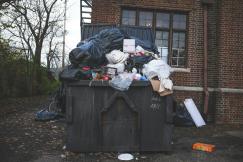 An illustrative photo of a black trash bin