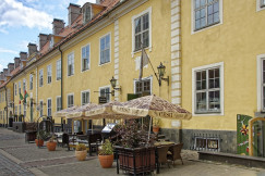 An illustrative photo of the cafe terrace near the yellow concrete building in Latvia
