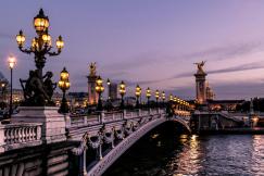 An illustrative photo of a bridge in Paris during night time