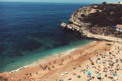 An illustrative photo of people by the sea during daytime