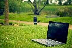 An illustrative photo of a laptop on the grass in the park