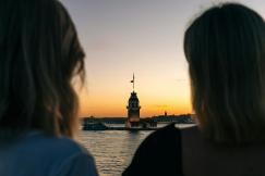 An illustrative photo of two people looking out over a body of water.