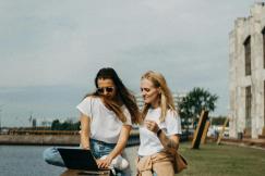 An illustrative photo of two women sitting near beach