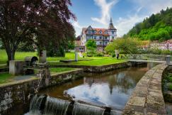 An illustrative photo of a picturesque outdoor scene featuring a small water canal with a waterfall in the foreground.