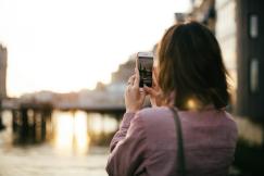 An illustrative photo of a woman holding a smartphone