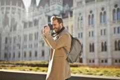 An illustrative photo of a man capturing images with a camera