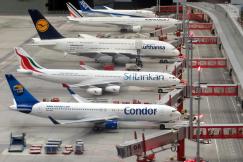 An illustrative photo of five planes standing in the airport 