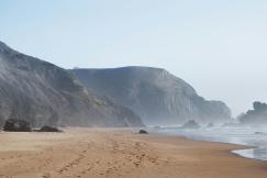 An illustrative photo of mountains near body of water.