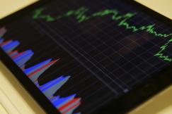 An illustrative photo of a tablet with black, blue and red graph illustration