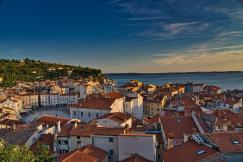 An illustrative photo of a picturesque coastal town during late afternoon.