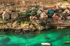 An illustrative photo of a village in Malta near a body of water