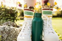 An illustrative photo of a person wearing white and yellow floral rain boots