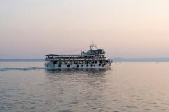 An illustrative photo of a large boat filled with people in a body of water
