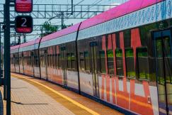 An illustrative photo of red and white train on the platform