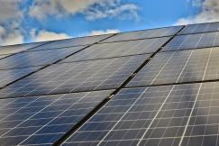 An illustrative photo of solar panels under a clear blue sky