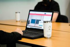 An illustrative photo of a person working on a laptop on a table