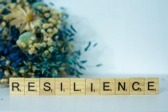 An illustrative photo of a scrabble type block spelling the word "resilience".
