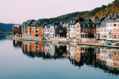 An illustrative photo of houses of different colours near the lake