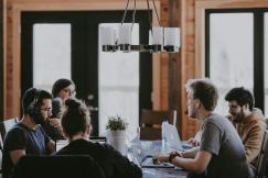 An illustrative photo of people working beside a table