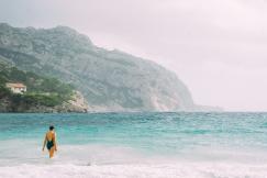 An illustrative photo of a woman going into the sea
