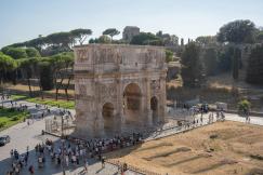 An illustrative photo of a group of people walking around an ancient building.