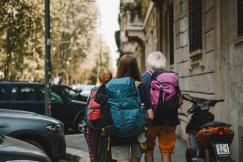 An illustrative photo of three people walking down a city street.