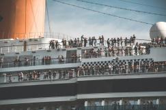 An illustrative photo of people on a white cruise ship 