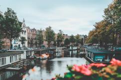 An illustrative photo of boats on water near buildings.