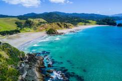 An illustrative photo of a beach with mountains in the background