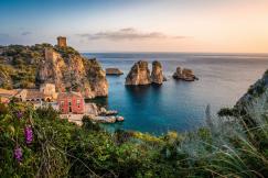 An illustrative photo of a house near a cliff and body of water