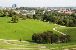 An illustrative photo of a grass field with a city in the background
