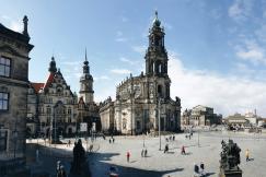 An illustrative photo of people walking in front of a large building in Dresden