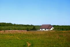 An illustrative photo of a house on grass field.