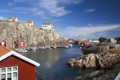 An illustrative photo of houses on the cliffs near a body of water in Sweden