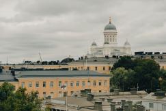 An illustrative photo of a large building with a dome on top of it during autumn