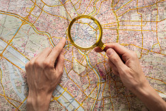 Top view hands holding magnifying glass