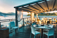 An illustrative photo of a restaurant with a view of the water.