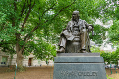 An illustrative photo of a monument of a sitting man