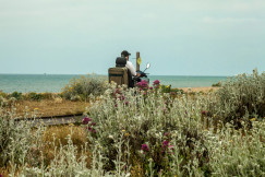 An illustrative photo of a man in a wheelchair on the seashore